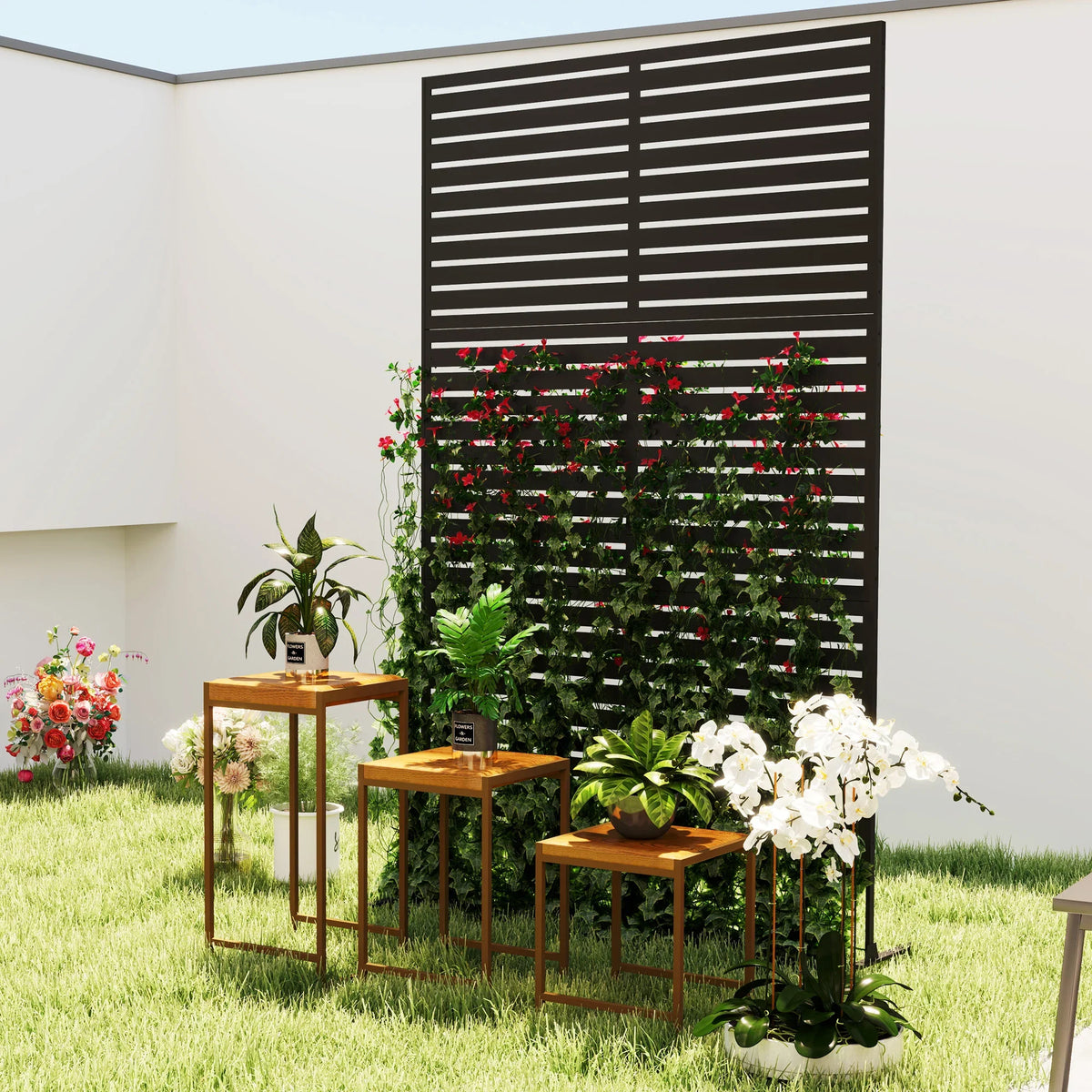 Black metal trellis privacy screen with flowering plants in backyard