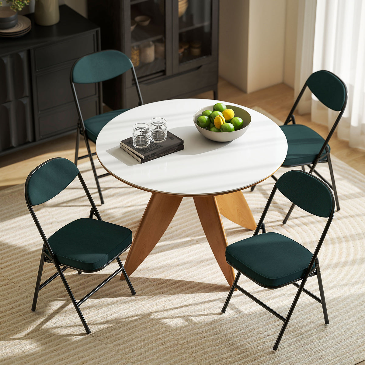 Teal folding dining chairs with corduroy seats and steel frames around round table