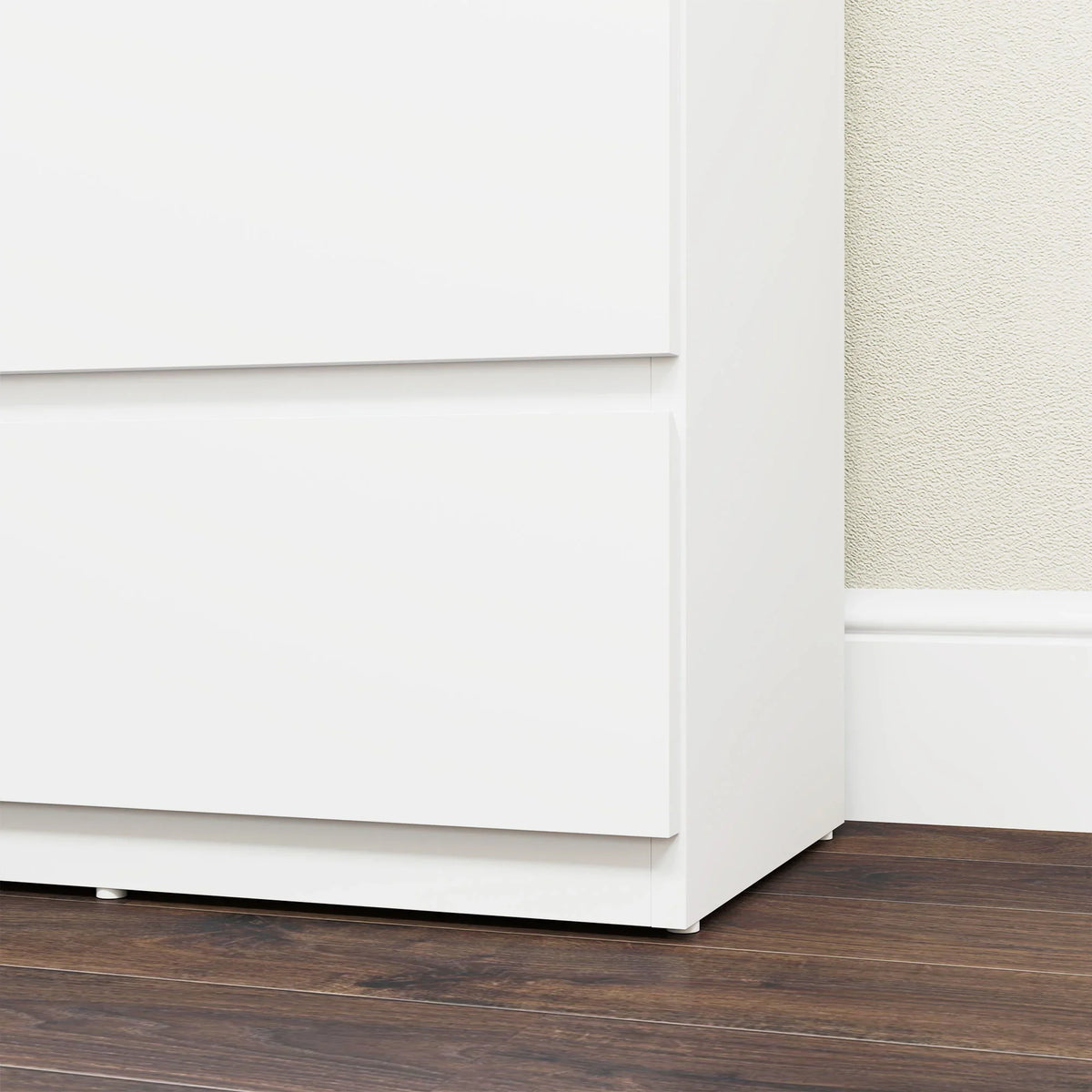 White 5-drawer dresser bottom corner with base panel and drawer opening gaps