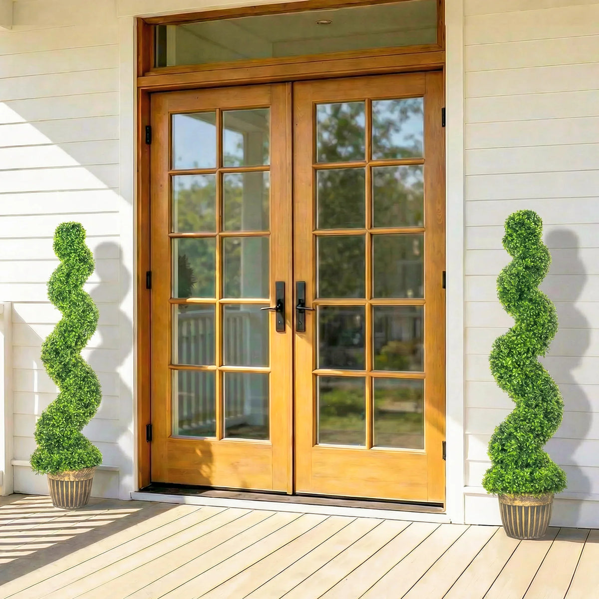 Set of two artificial spiral boxwood trees with green foliage in ribbed pots