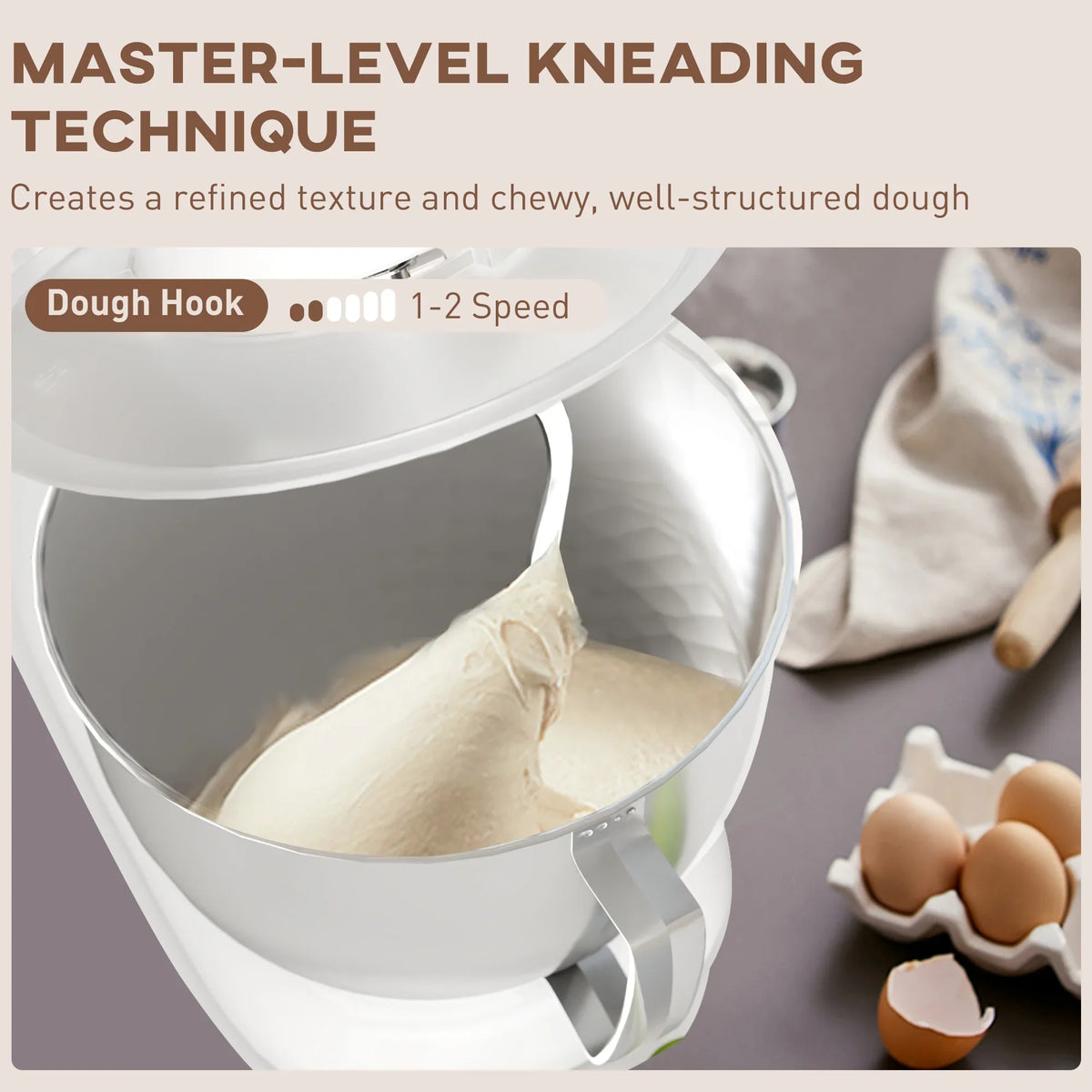 White stand mixer with stainless bowl and dough hook kneading dough