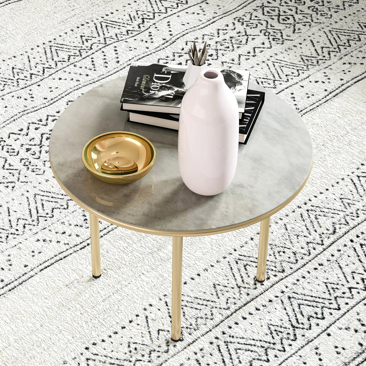 Beige round table with faux marble top and gold-tone legs on patterned rug
