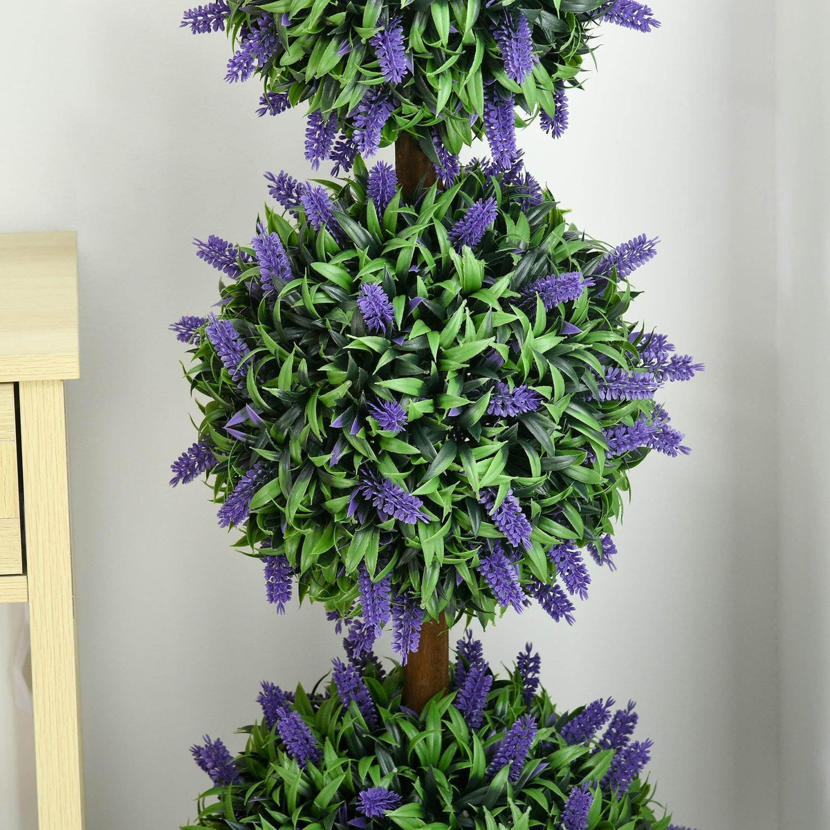 Tall artificial ball tree with layered purple flower clusters and green foliage, full view