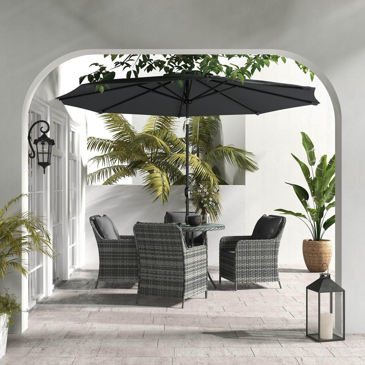 Outdoor dining set with umbrella, gray wicker chairs, dark cushions, glass-top table