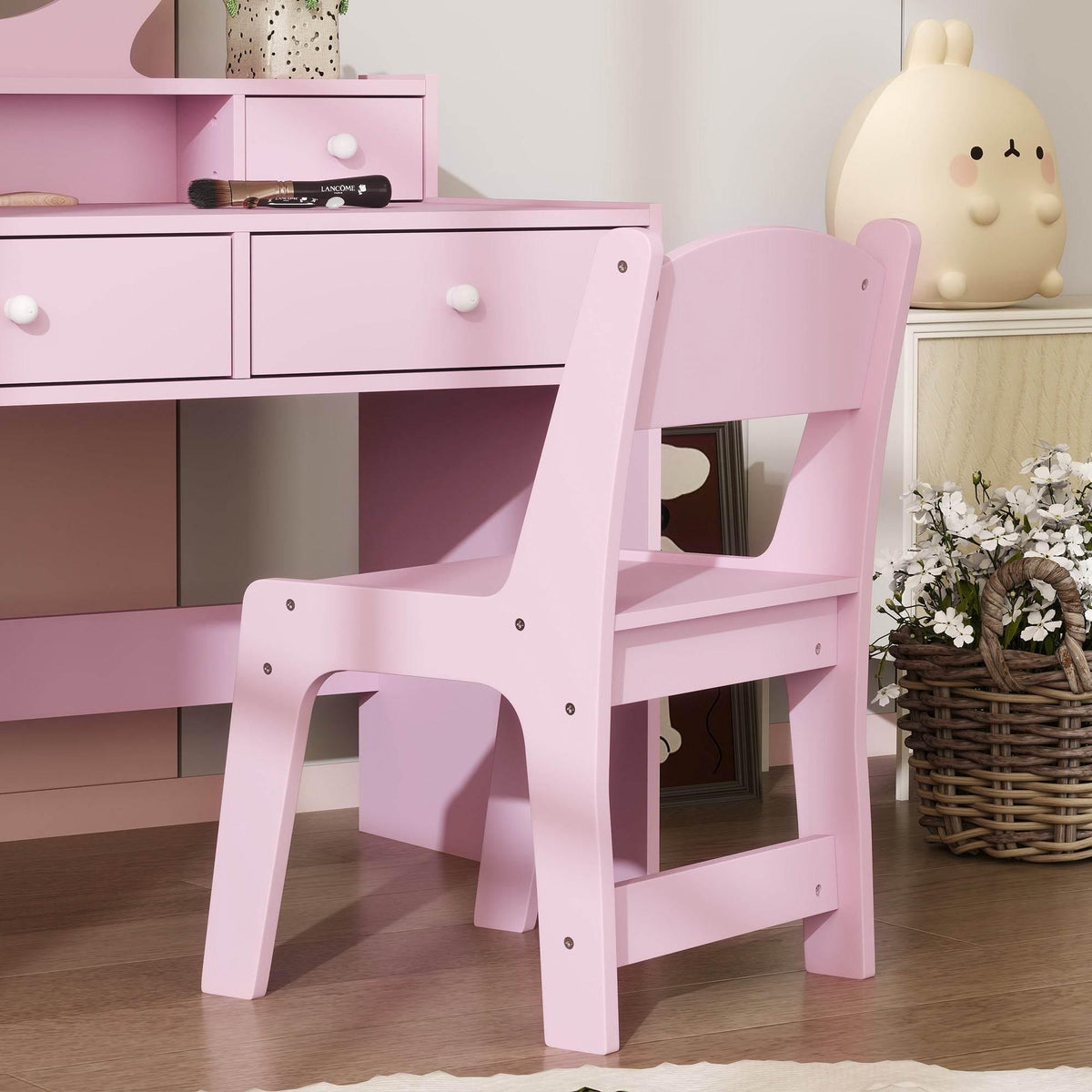 Pink kids makeup vanity set and matching stool with open cubbies under counter