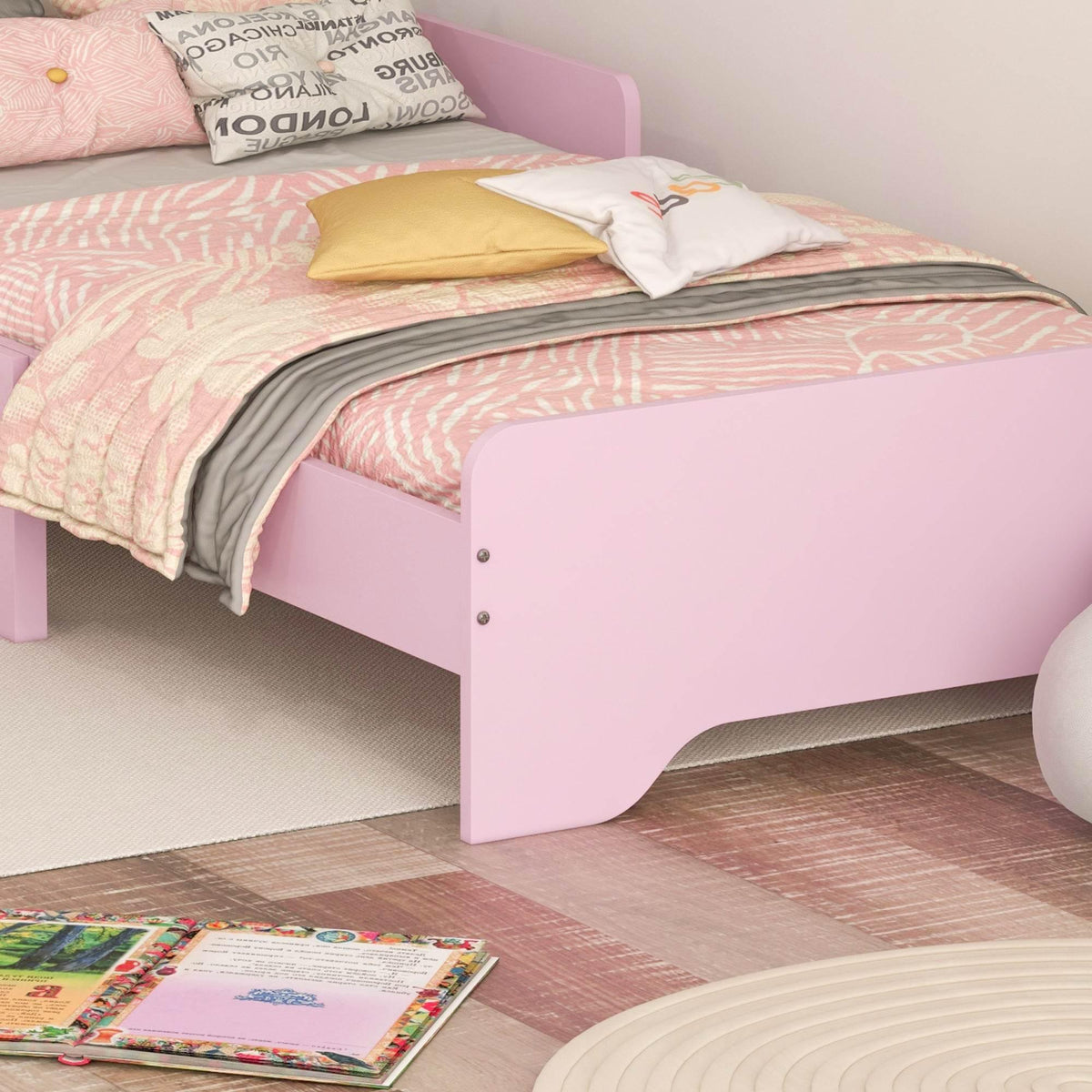 Pink kids bed with cloud-shaped headboard panel and sturdy side frame