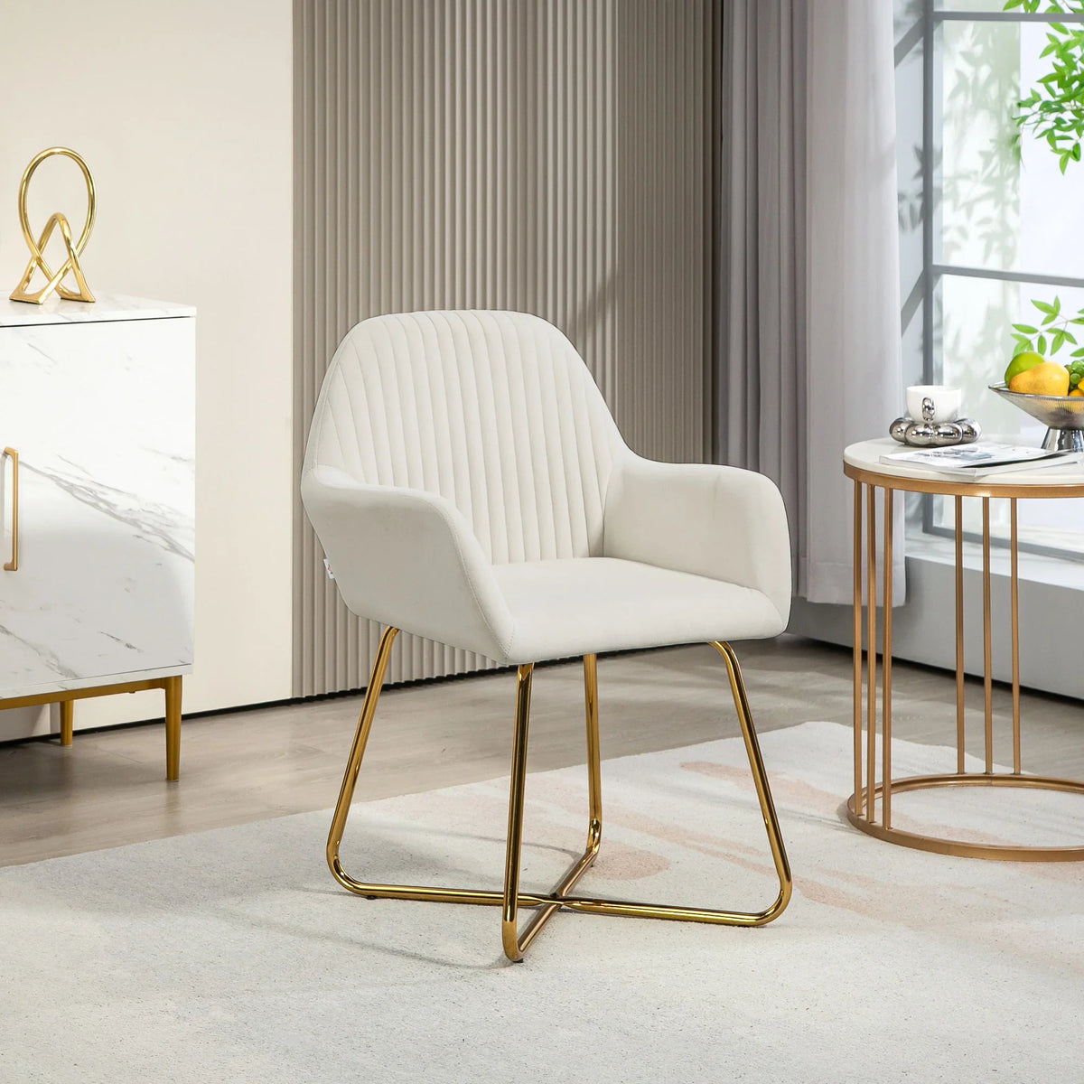 Cream accent arm chair with channel tufting, curved arms, and gold metal base