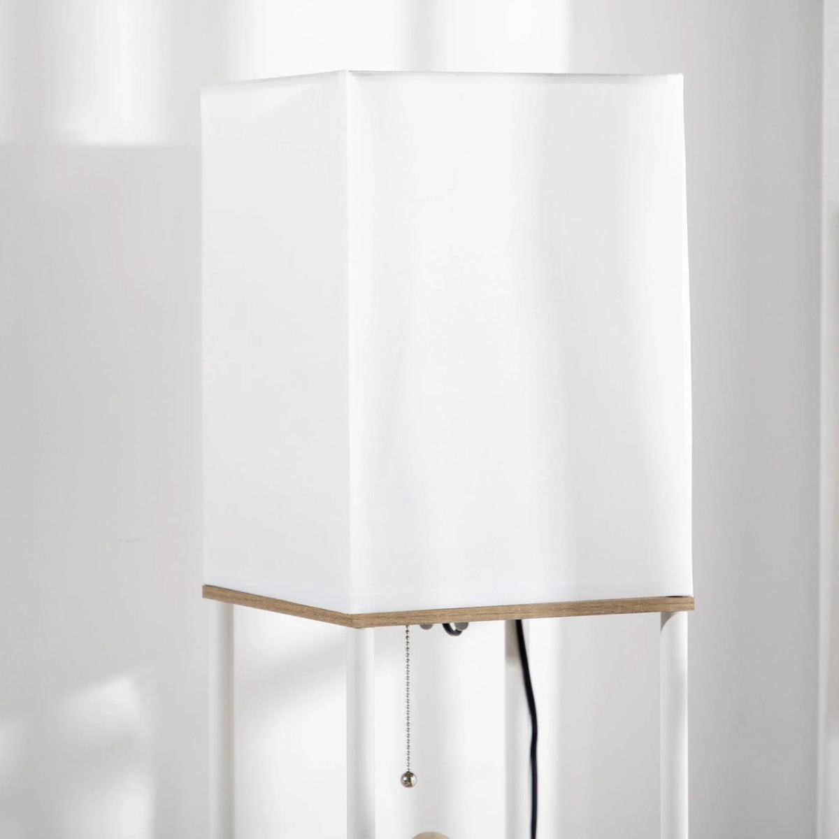 Close-up of white fabric lampshade on a tall floor lamp frame