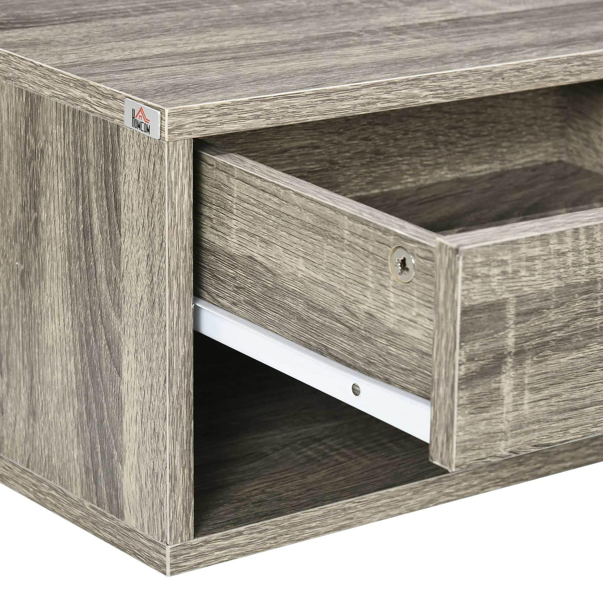 Close-up of floating nightstand drawer front and handle, light gray-brown wood