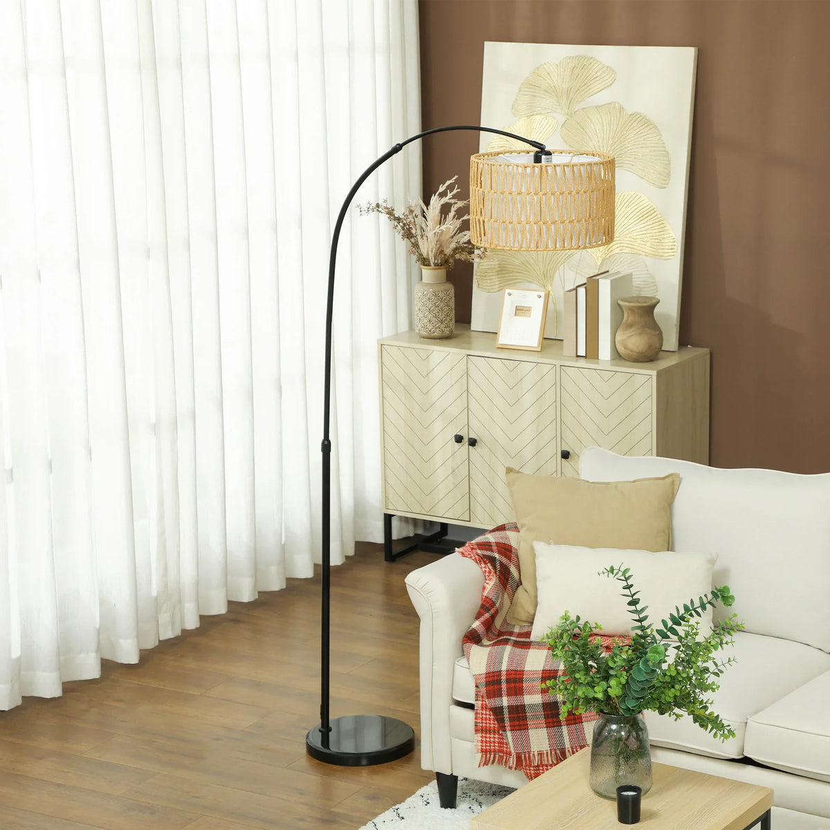 Black arched floor lamp with beige rattan woven shade and round base