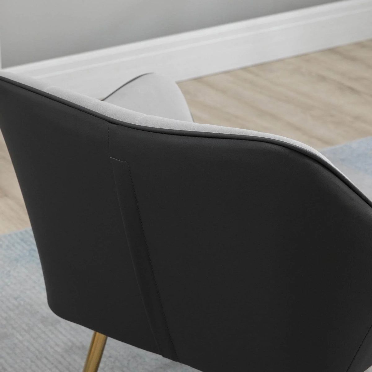 Dark accent armchair with curved armrest and upholstered seat