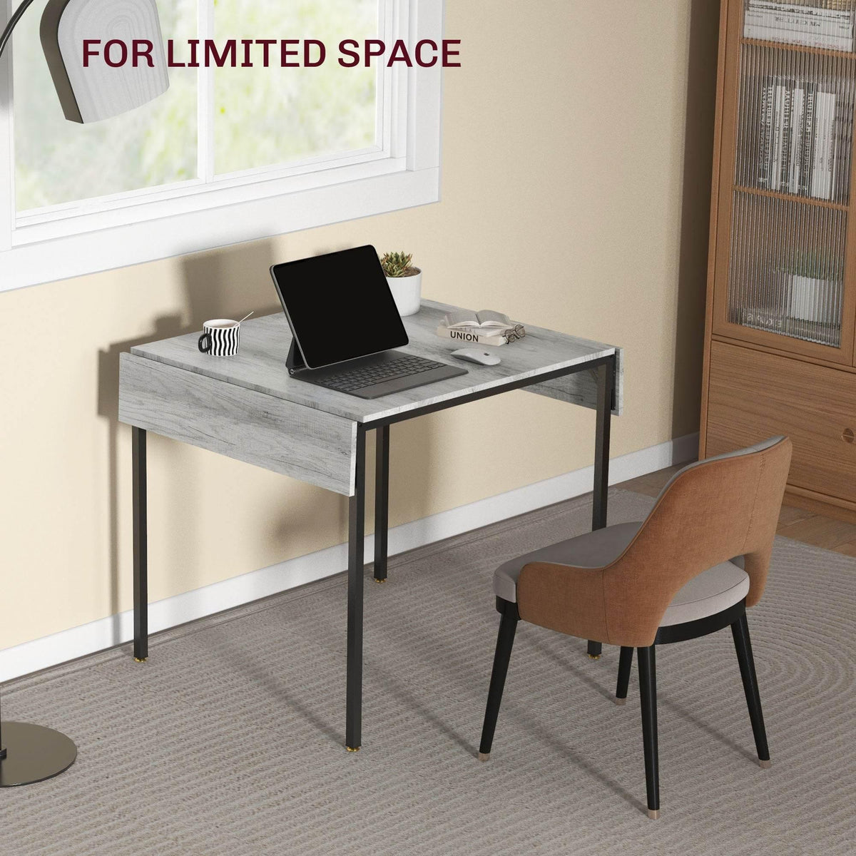 Grey drop-leaf folding table with black legs, laptop on tabletop for small spaces