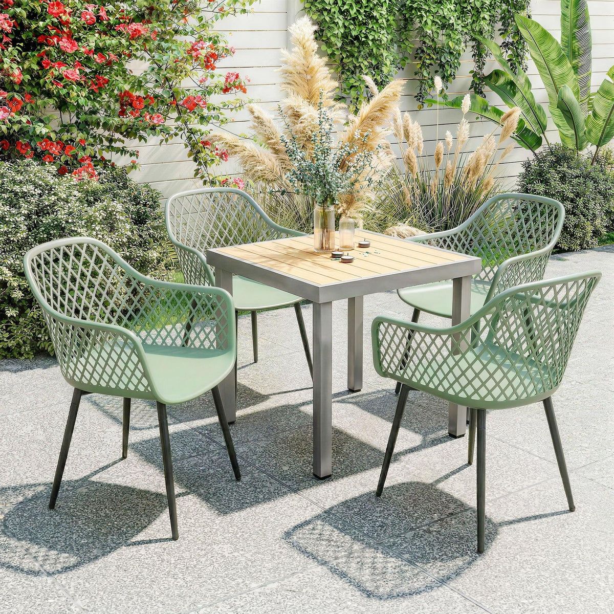 Set of 4 mint green patio chairs with cut-out diamond lattice backs and armrests