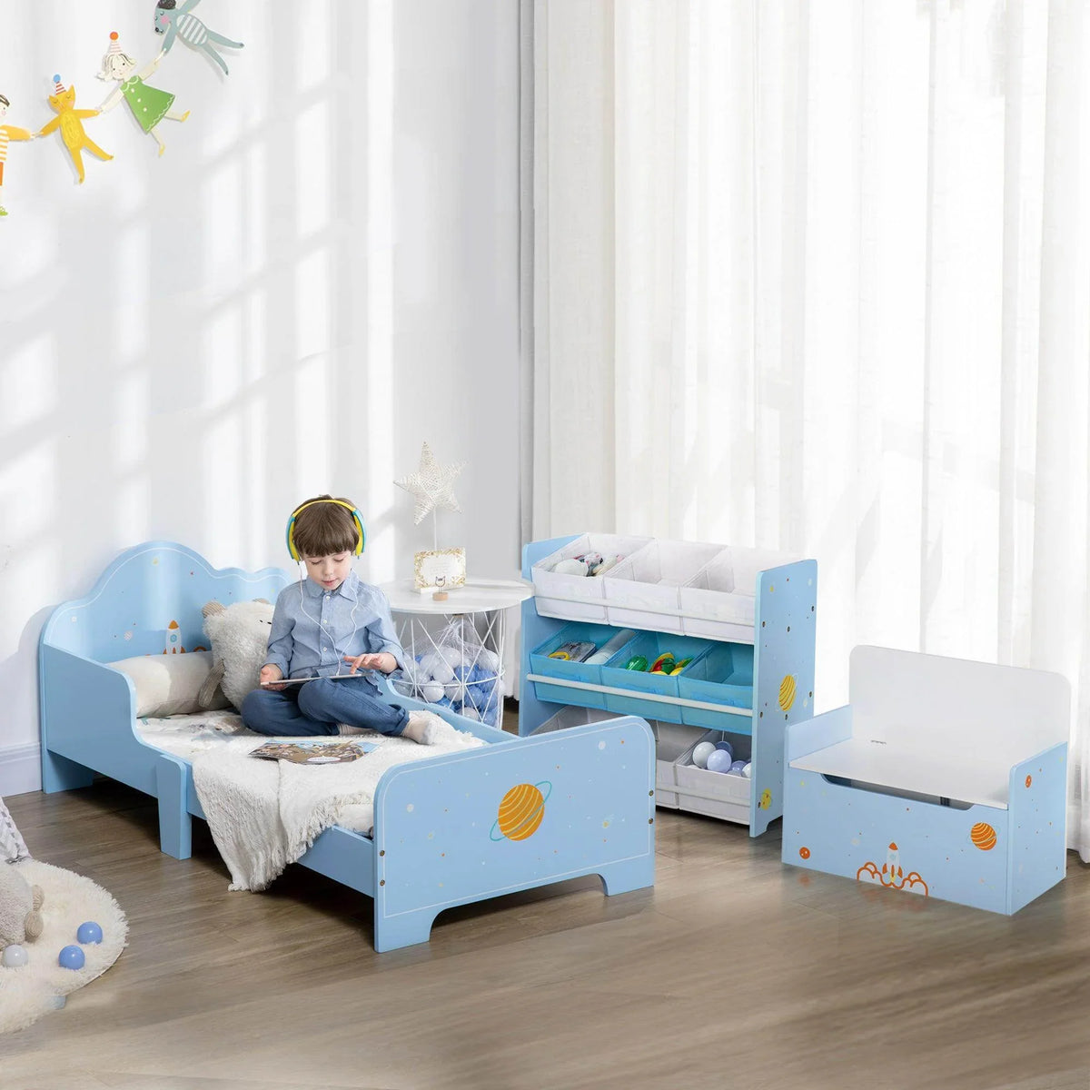 Kids blue low-bed set with side rails, open storage shelf, and matching toy box