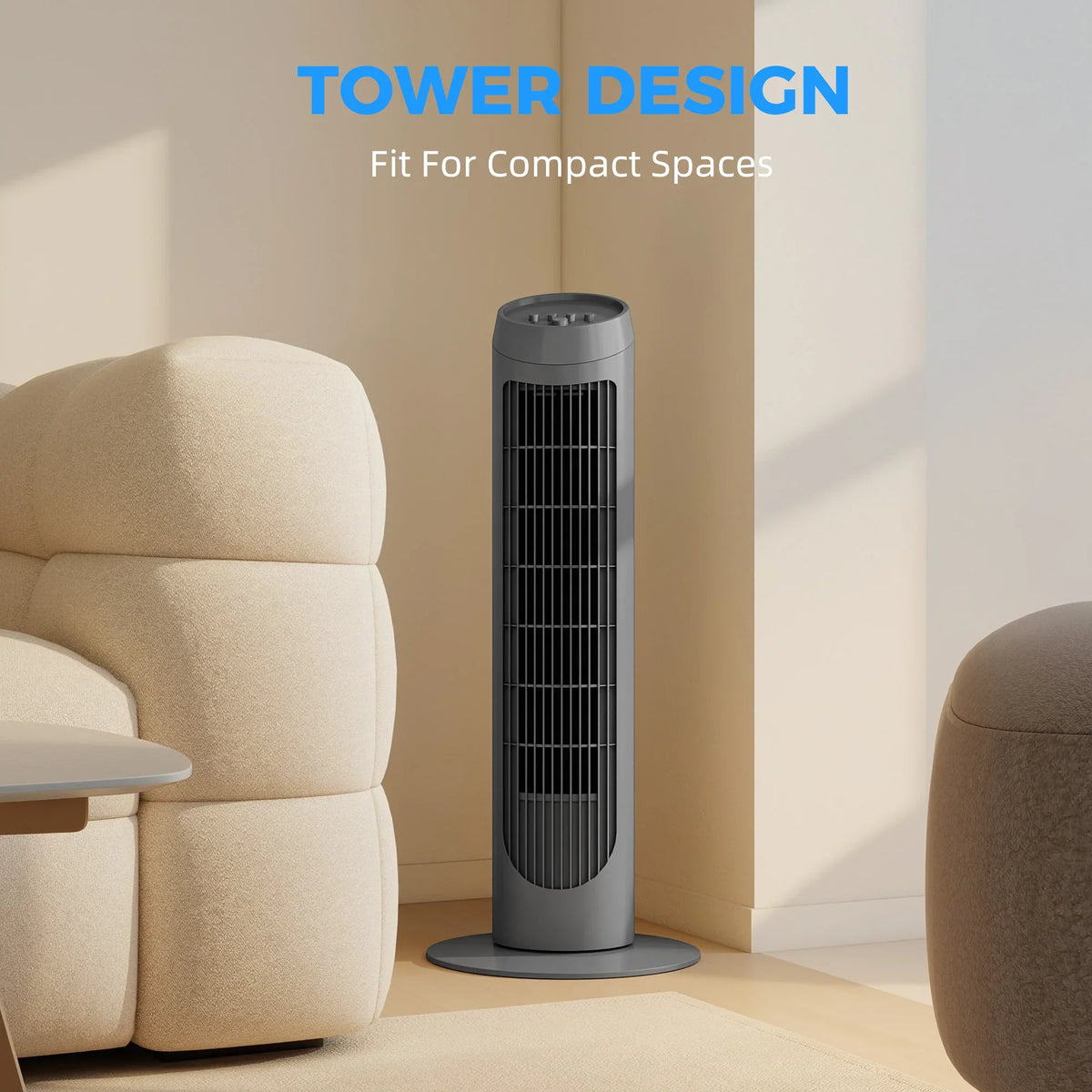 Grey tower fan standing between couches, slim vertical design with base