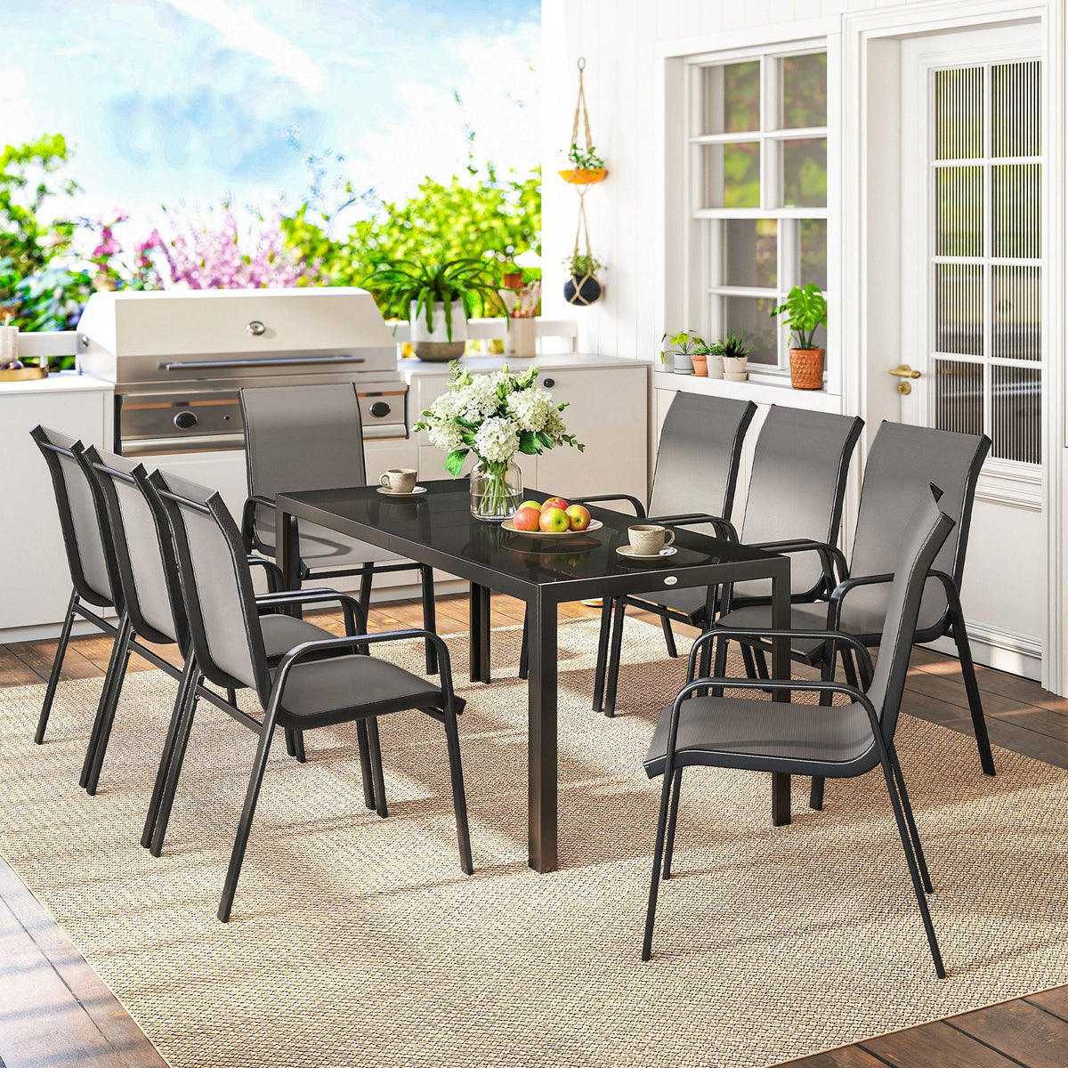Outdoor dining set on patio with dark grey chairs and tempered-glass table
