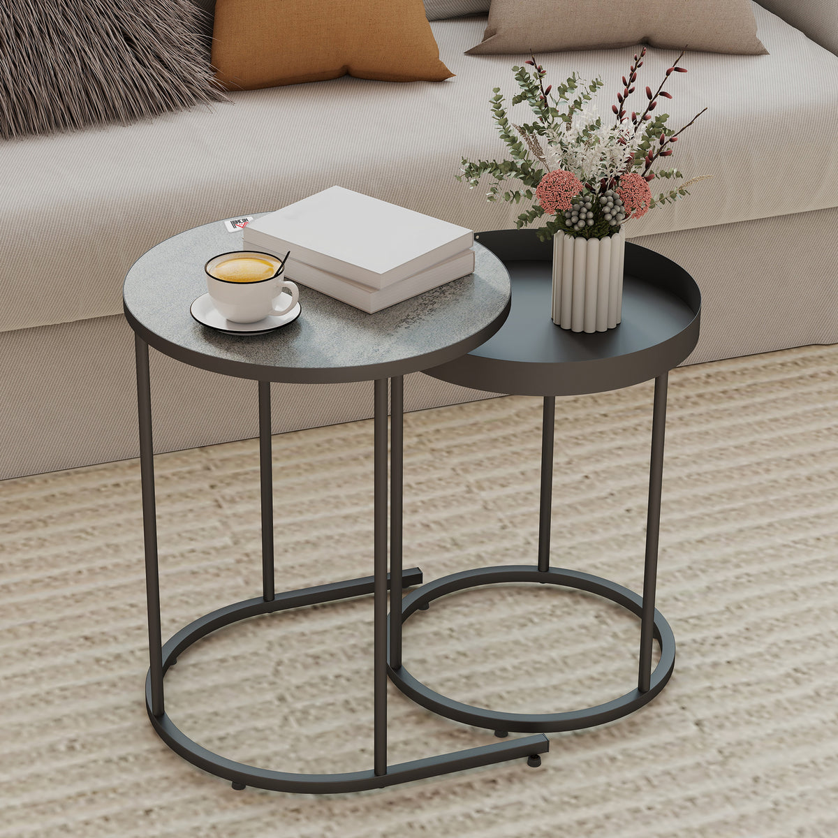 Nesting table set of two with round grey tops and dark metal open circular base