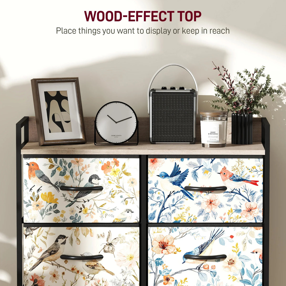 Wood-effect top and floral fabric drawer fronts on black frame, close-up view