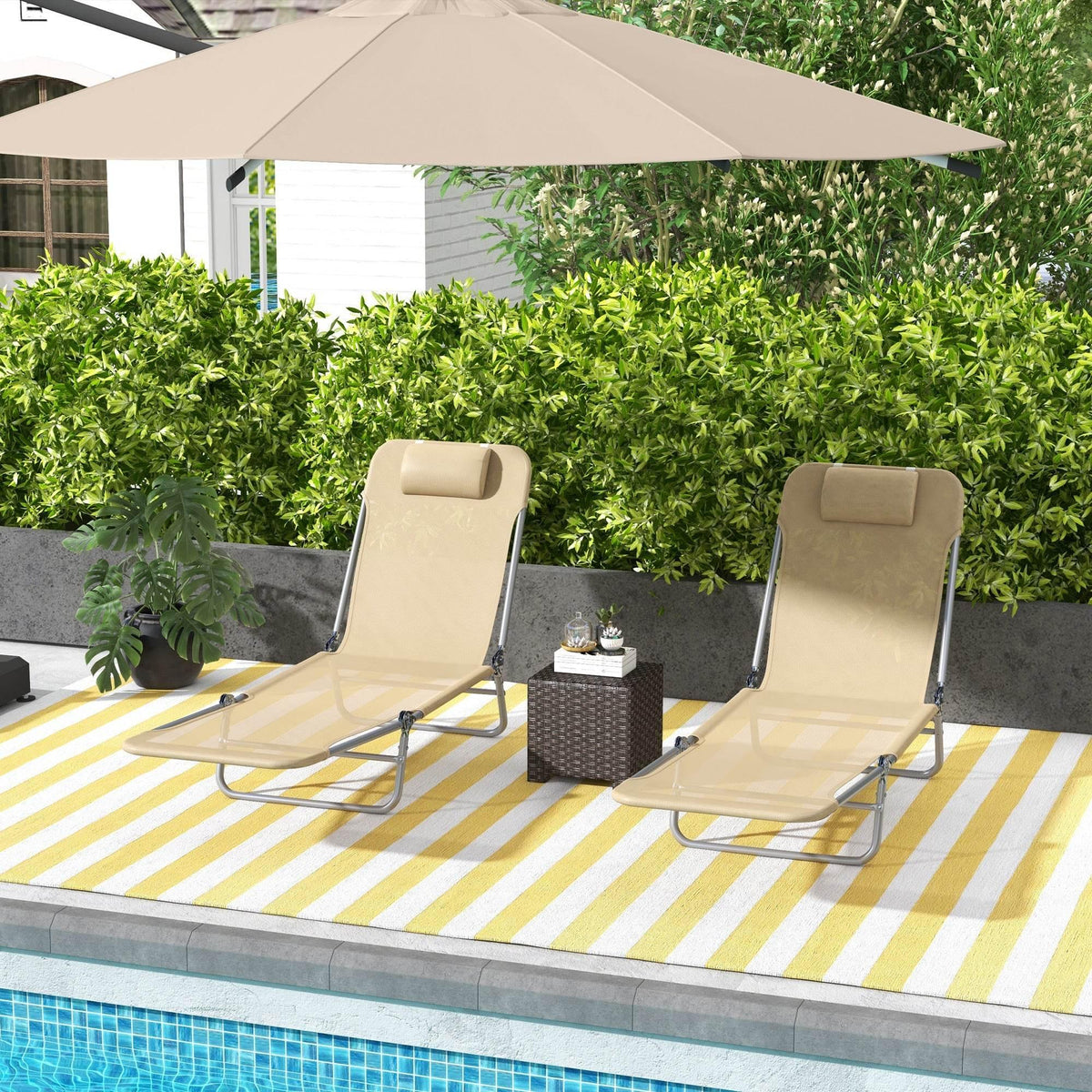 Set of two adjustable sun loungers with beige cushions, padded headrests, and steel frames