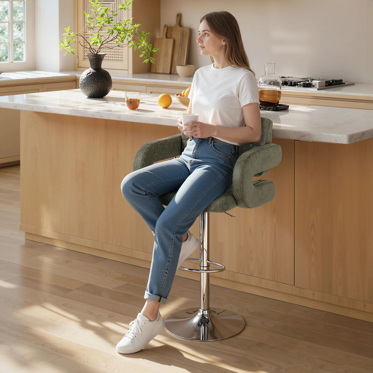 Green upholstered swivel bar stool with backrest, armrests, and chrome footrest base