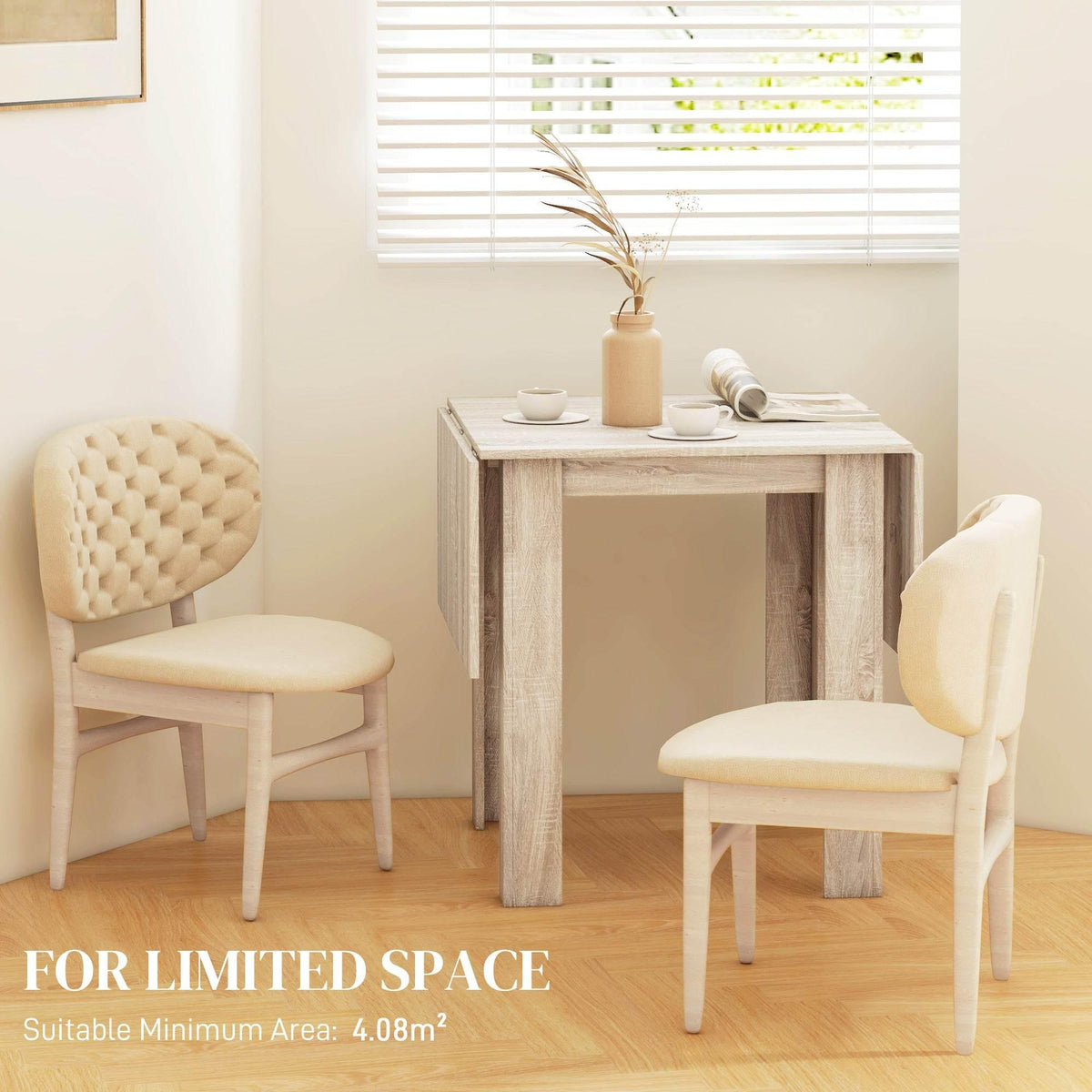 Light oak drop-leaf dining table in a small dining setup with two chairs