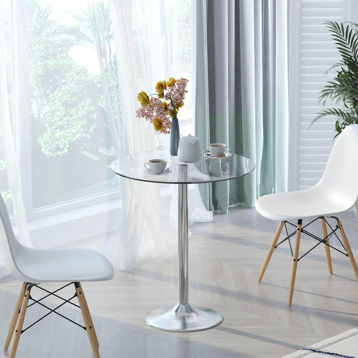Round glass dining/bar table with clear top and polished steel pedestal base.