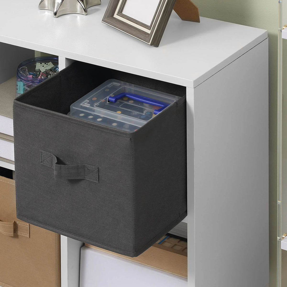 Dark gray fabric drawer with front handle inside white cube storage cabinet
