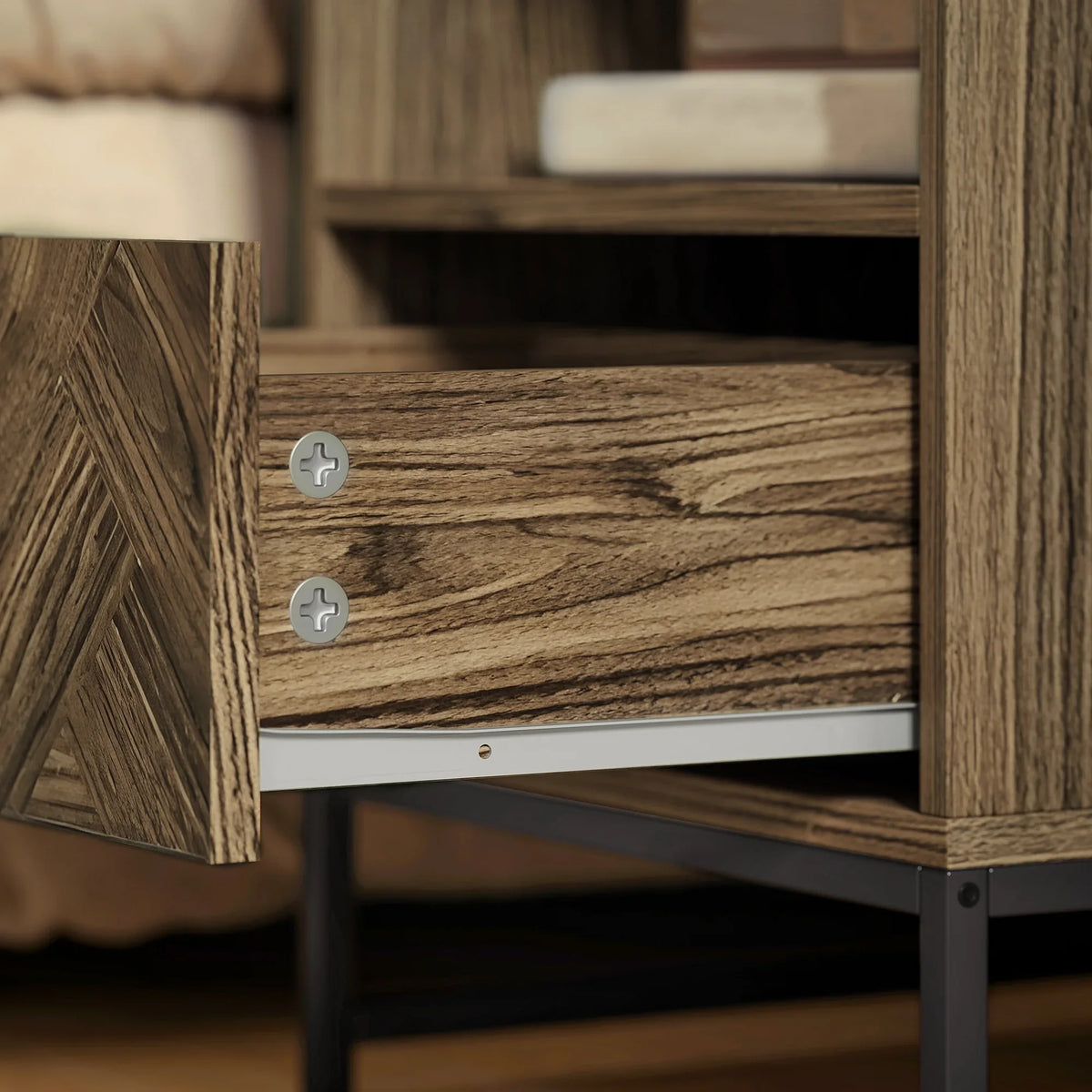 Close-up of brown wood-effect drawer front with metal knobs