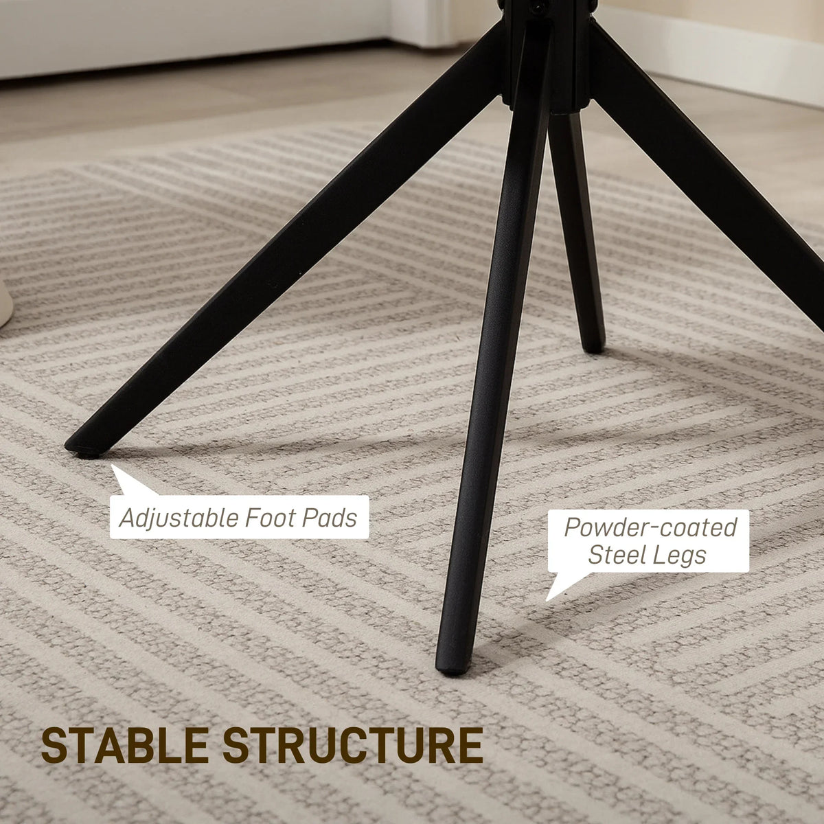 Black powder-coated steel legs of swivel accent chair, close-up under seat