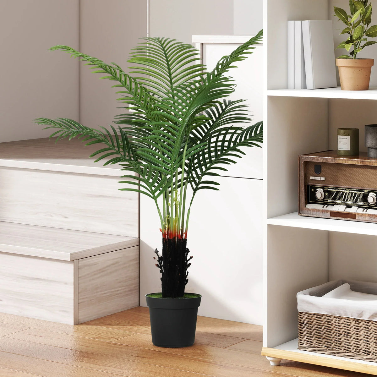 Artificial areca palm tree with green fronds in black plastic pot