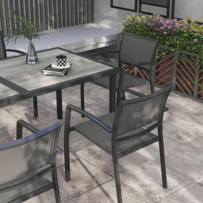 Grey patio dining set with rectangular table and mesh-back chairs