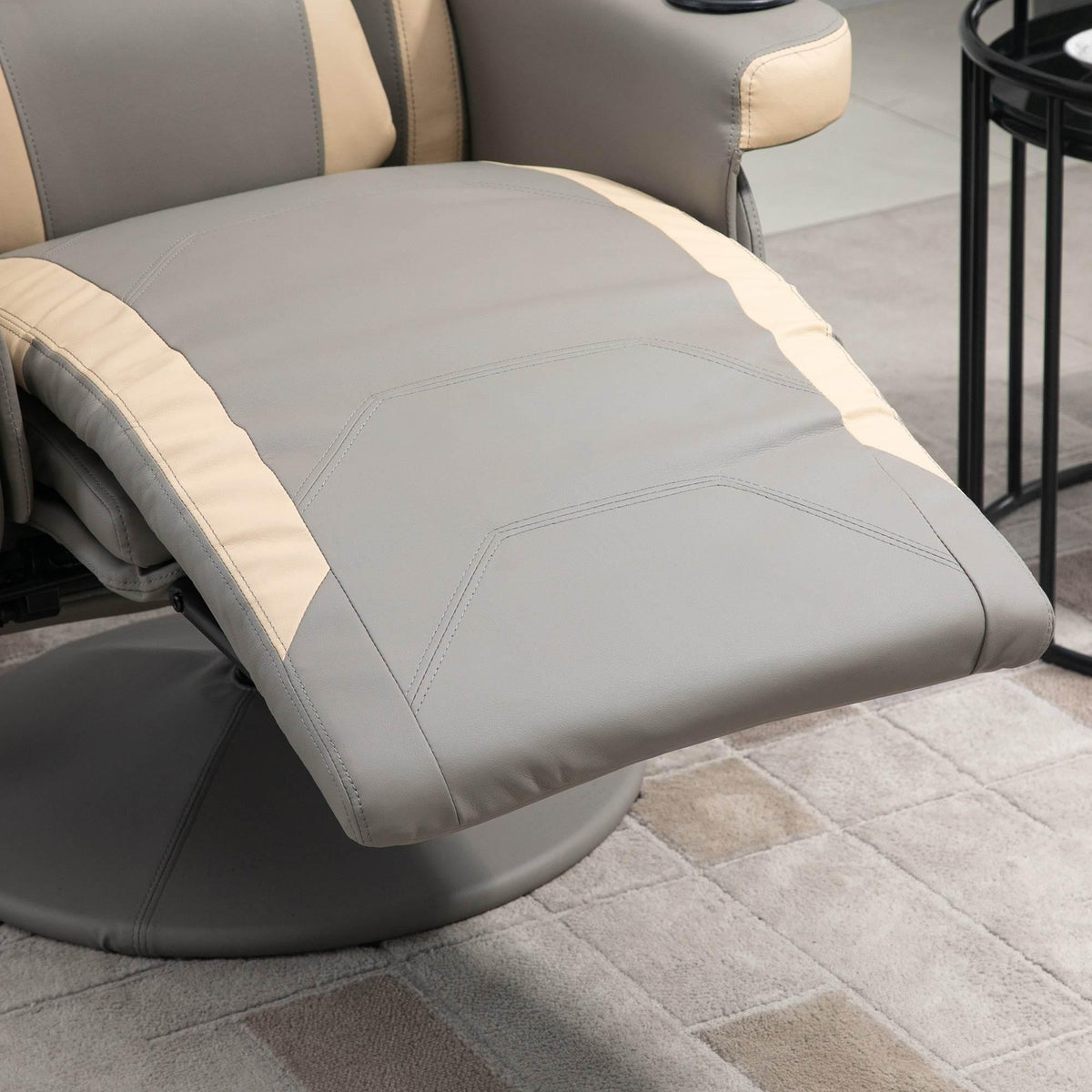 Grey padded recliner footrest and seat cushion with beige trim and stitched seams.