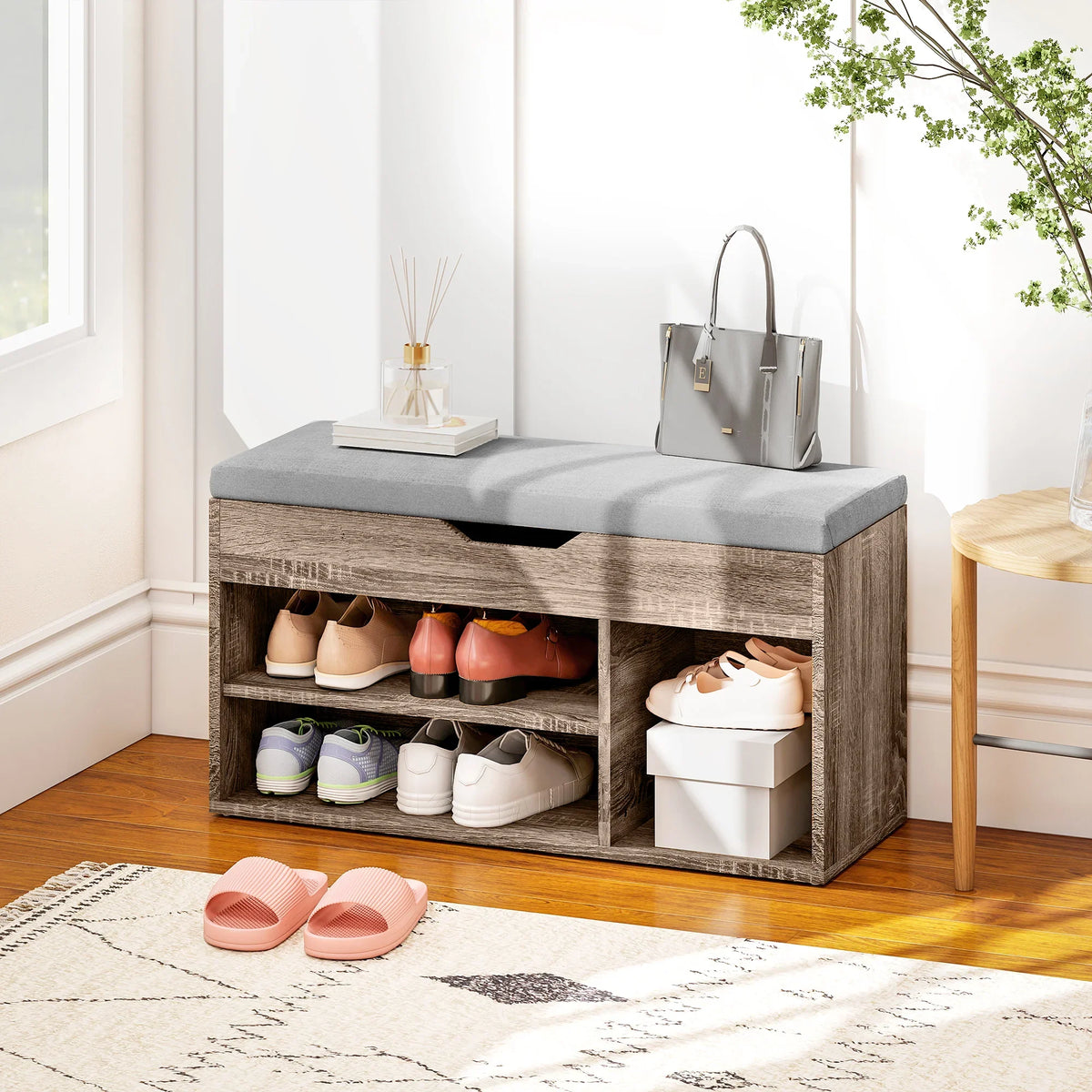 Grey padded bench seat over shoe cabinet with open shelves and hidden storage