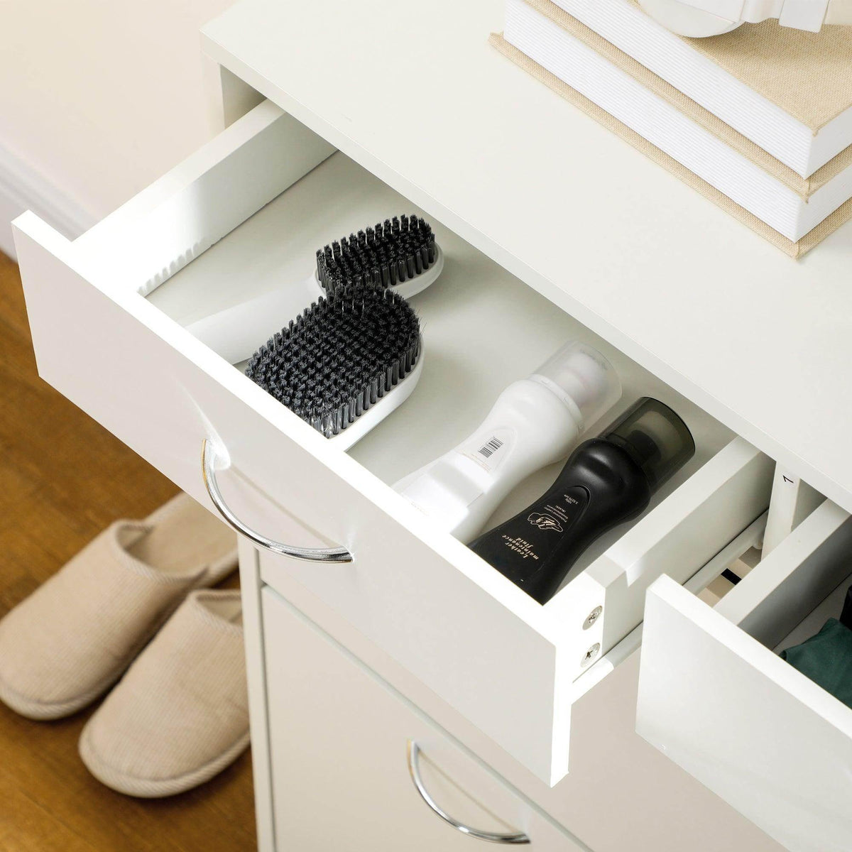 Open white flip drawer showing divided compartments for shoes and accessories