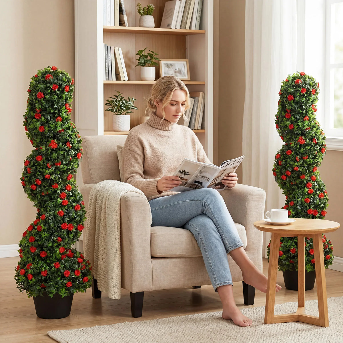 Two spiral rose topiary trees with red blooms and green leaves in black pots