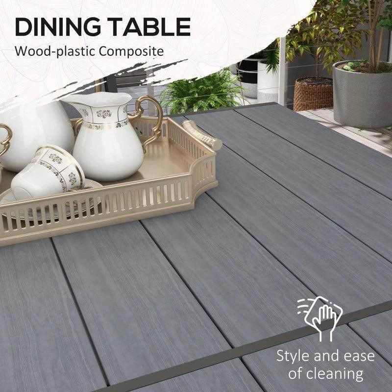 Light grey wood-plastic composite dining table with tabletop decor items