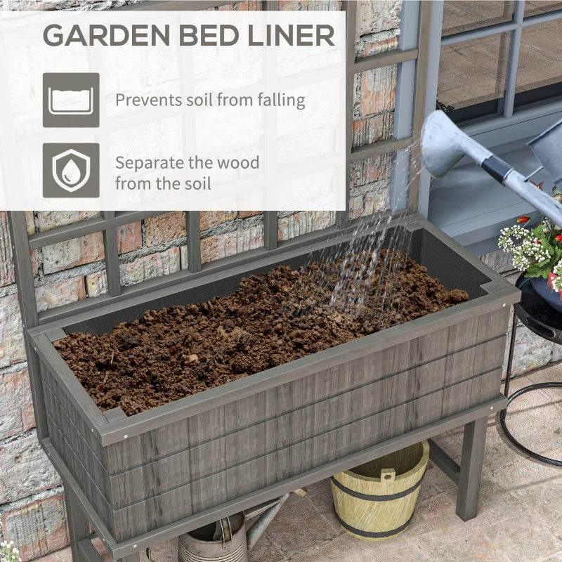 Grey raised garden planter with liner holding soil in the rectangular bed