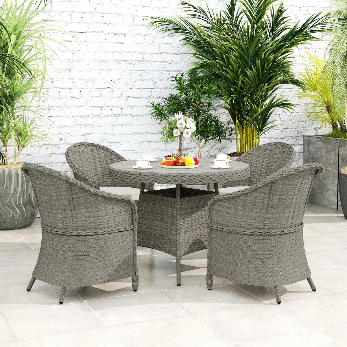 Grey woven rattan 4-seater dining set with glass-top round table and cushioned chairs