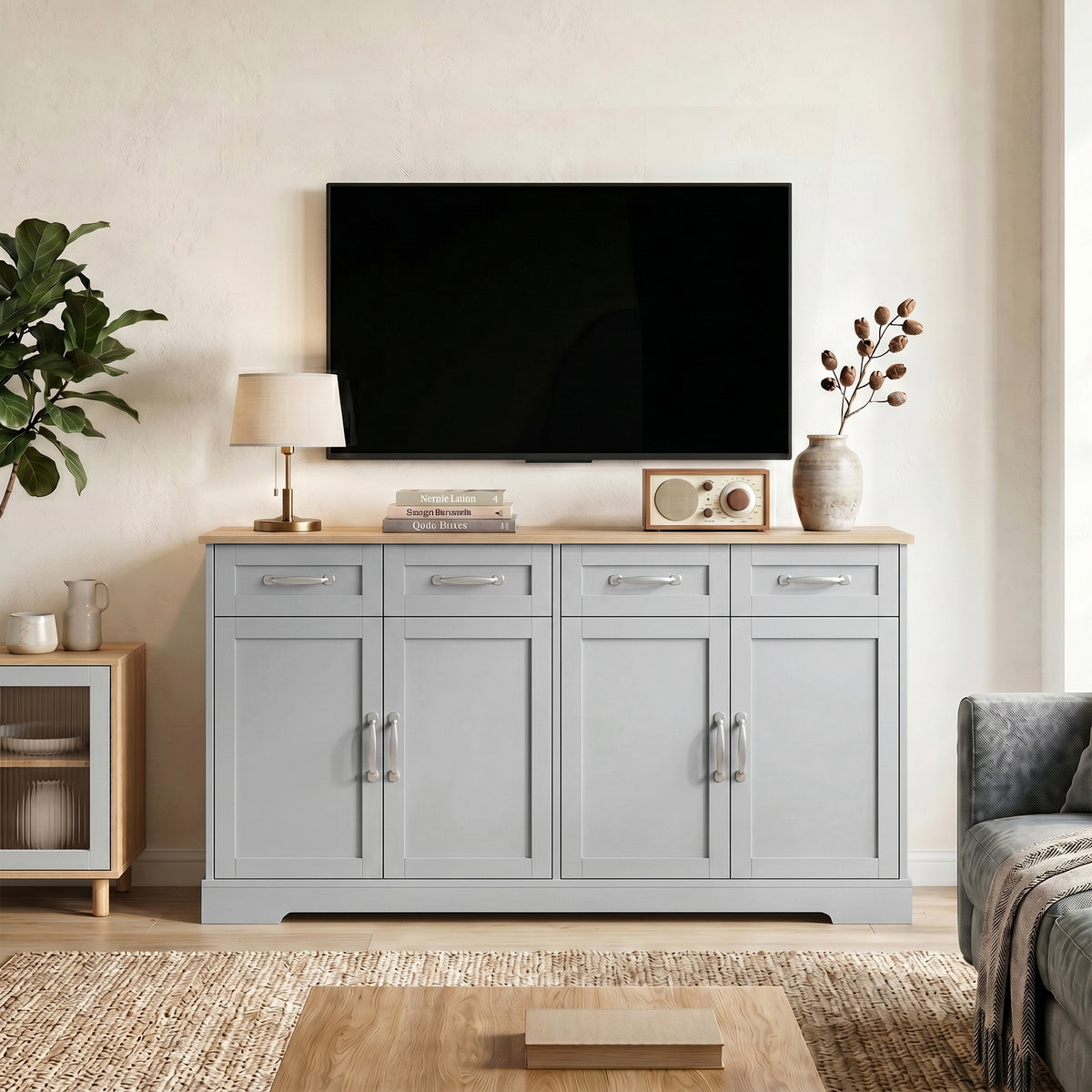 Grey sideboard cabinet with four doors and four drawers, placed under a TV