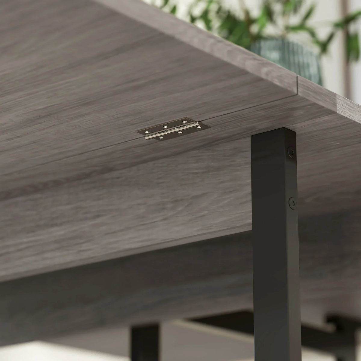 Grey drop-leaf table hinge and support bracket under the tabletop