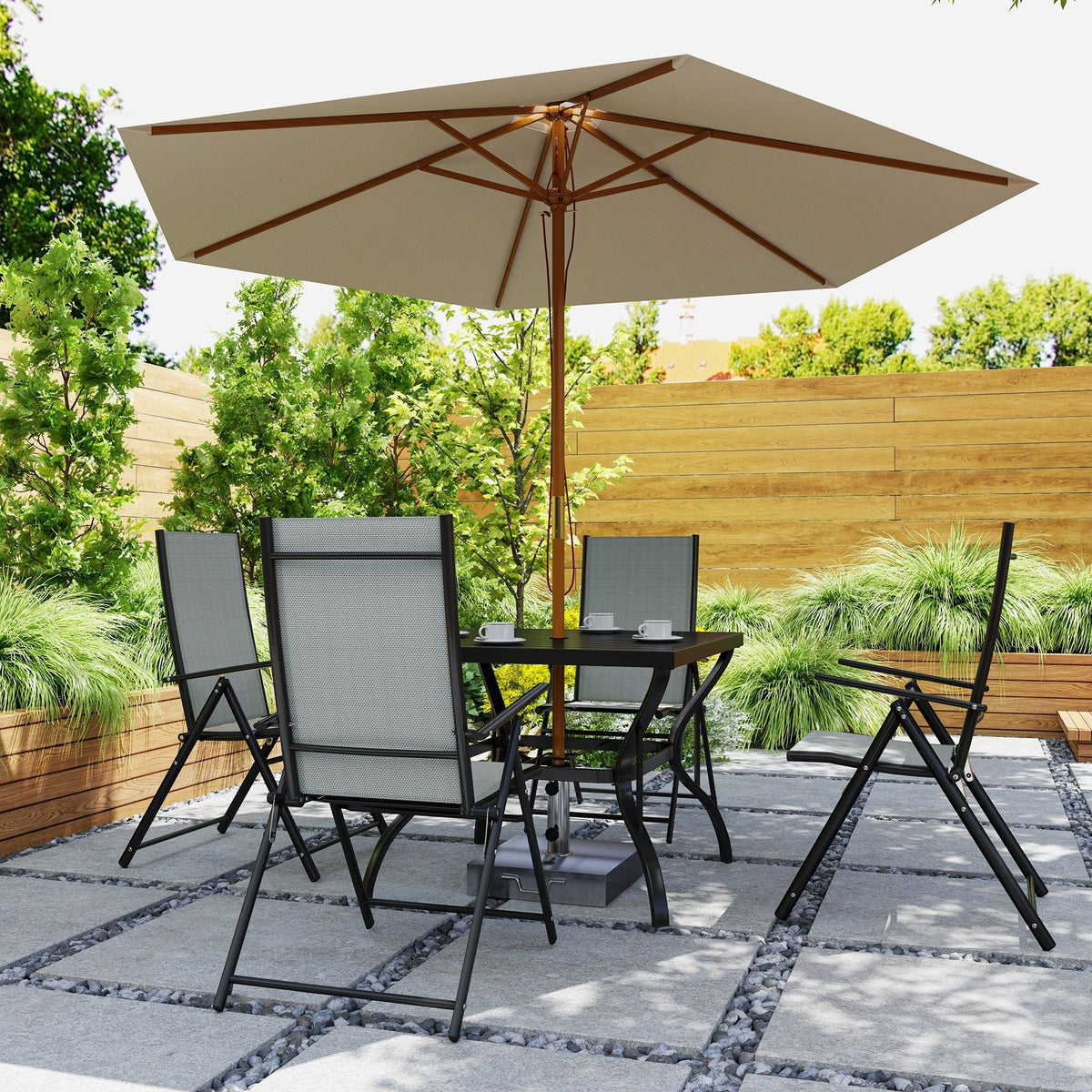 Grey and black patio dining set under beige umbrella with four folding chairs and square table