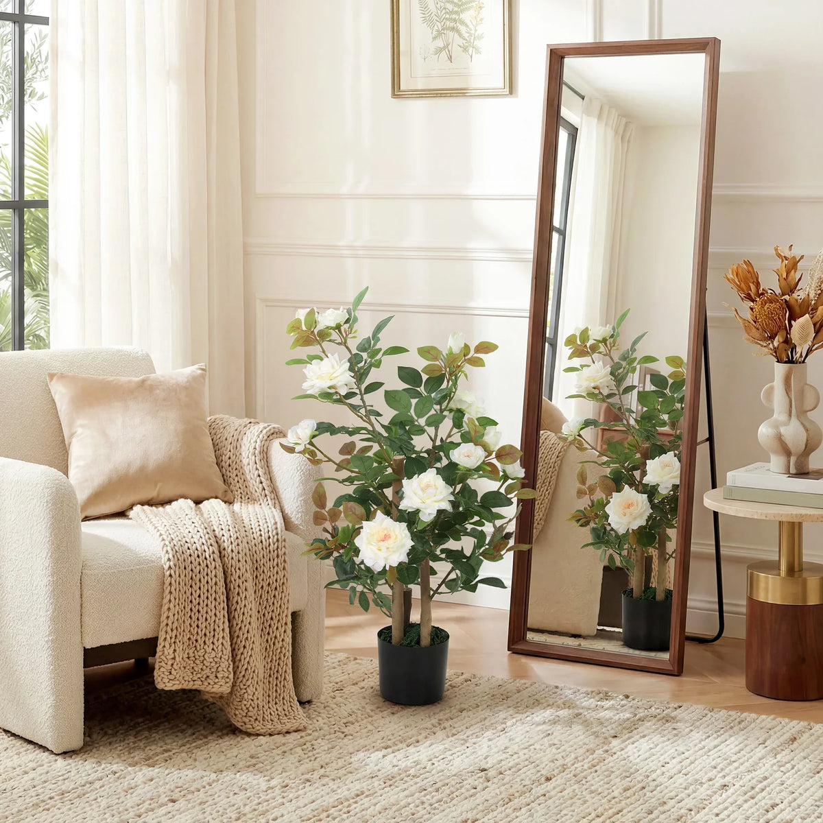 Artificial rose tree with white blossoms and green leaves in black pot, indoor floor decor