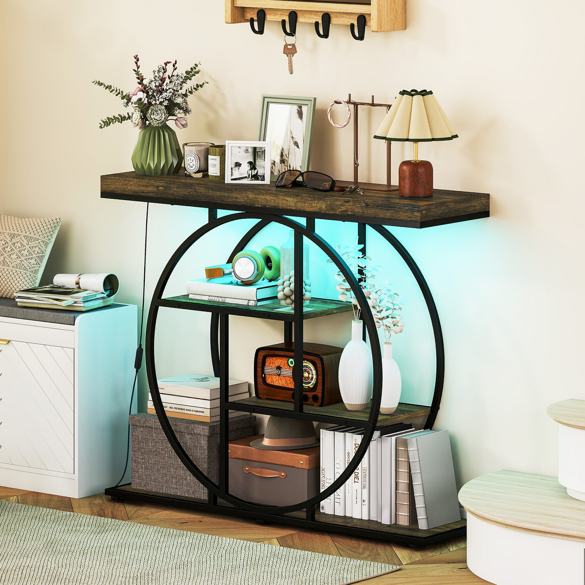 Industrial console table with circular metal frame, open shelves, dark wood top, blue LED glow.