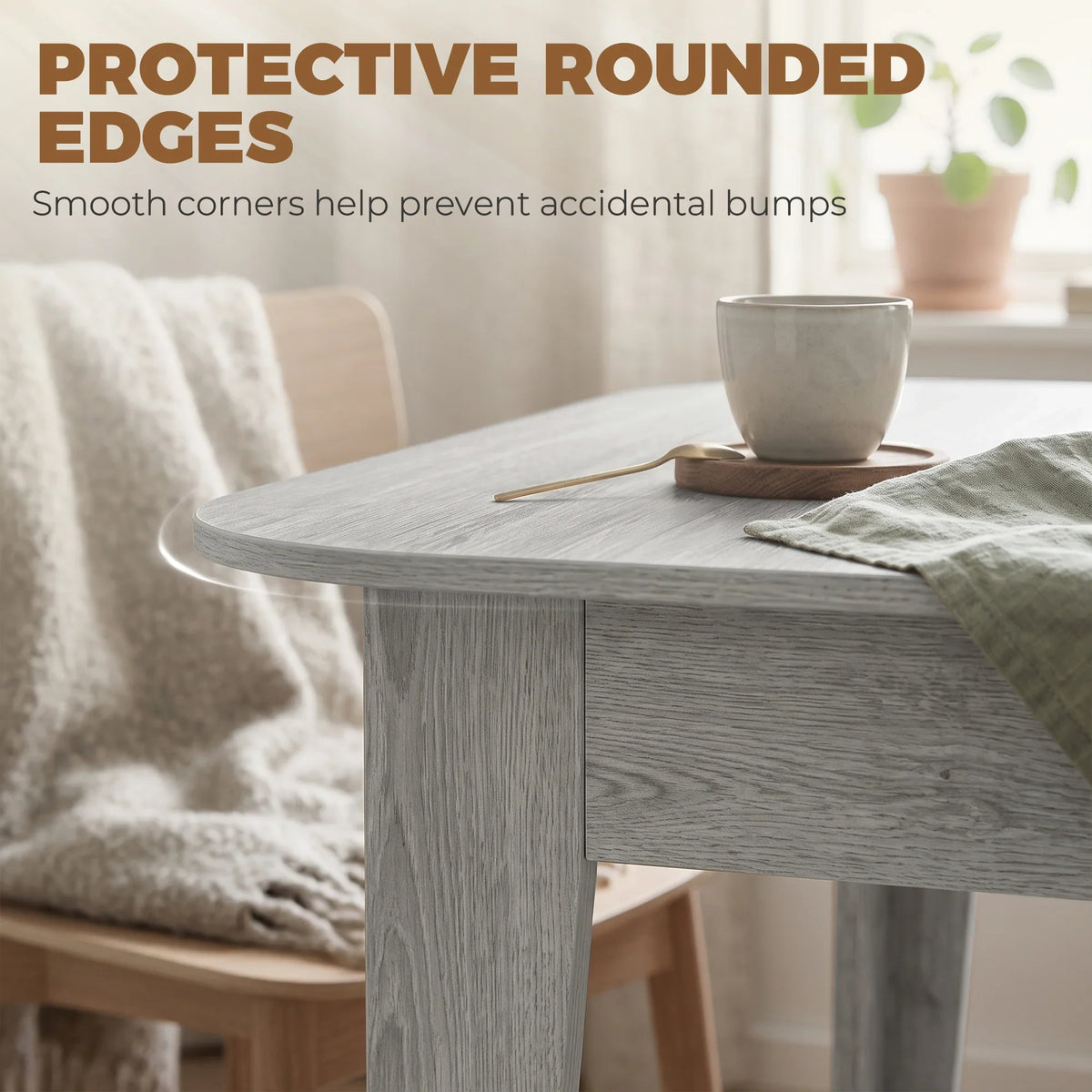 Grey wood-effect extendable oval dining table with protective rounded corners and tabletop edge.