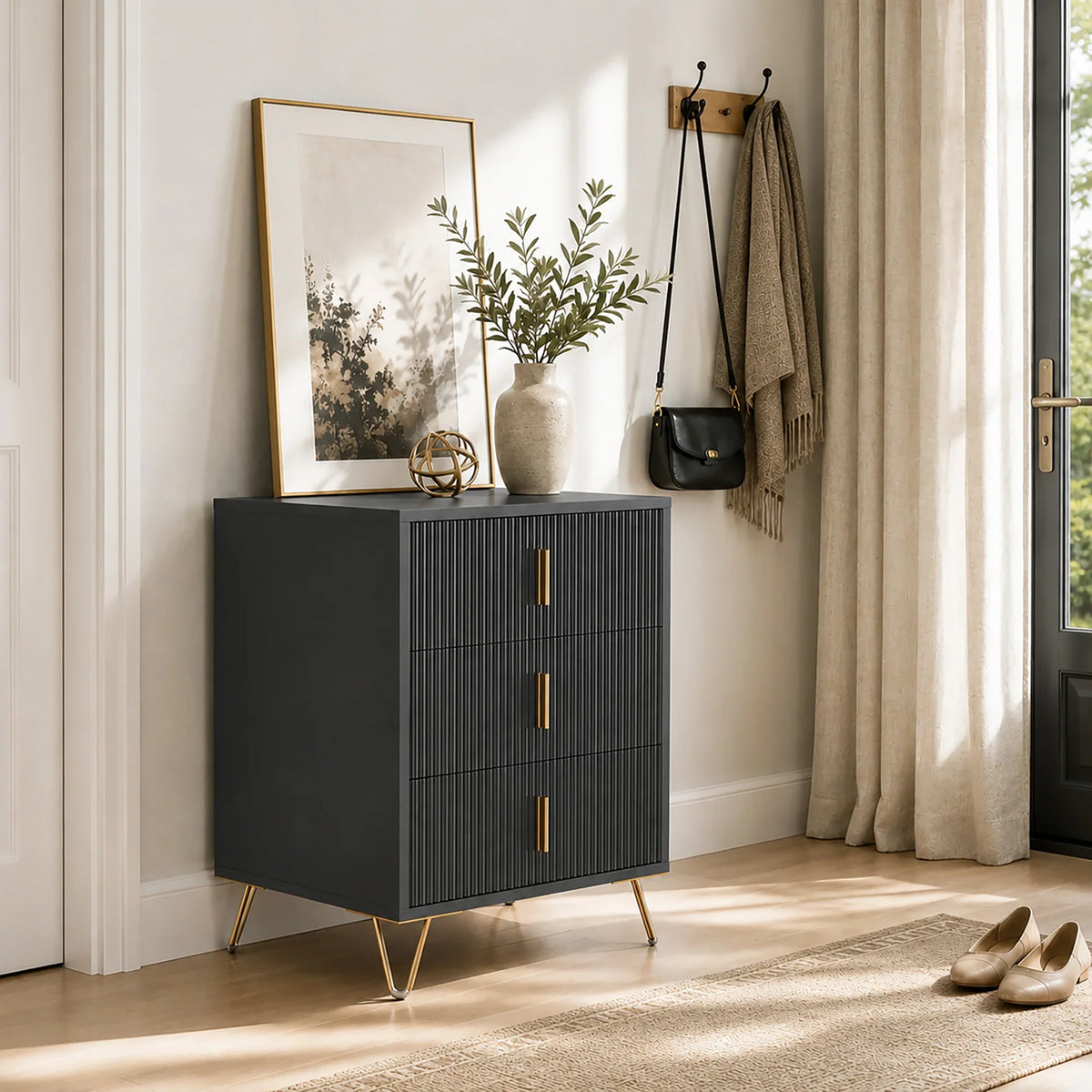 Black fluted 3-drawer dresser with gold handles, gold legs, and flat top for decor.