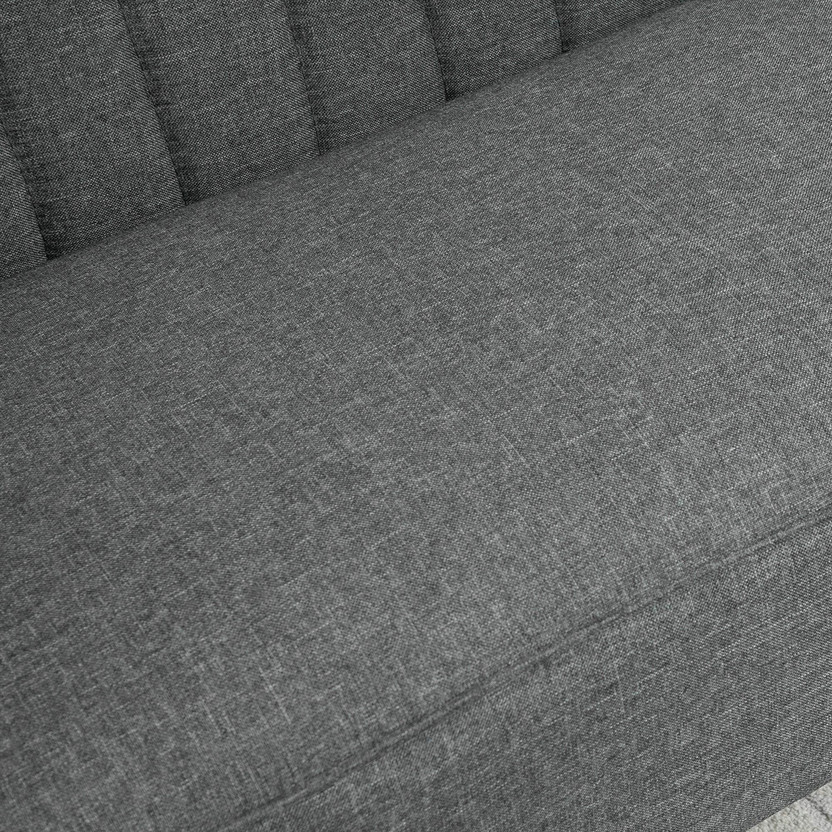 Grey linen-feel fabric upholstery on the sofa seat cushion