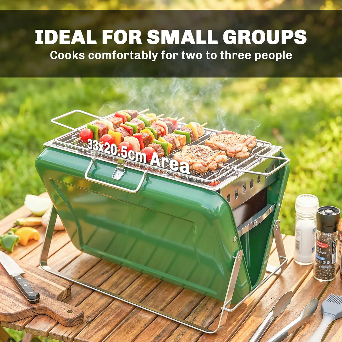 Green portable charcoal grill on wood deck with skewers cooking on wire grate