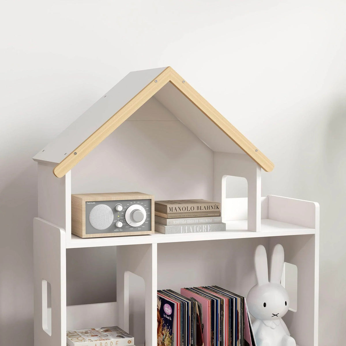 White house-shaped toy storage shelf with 6 cubbies, books and plush bunny on lower shelf