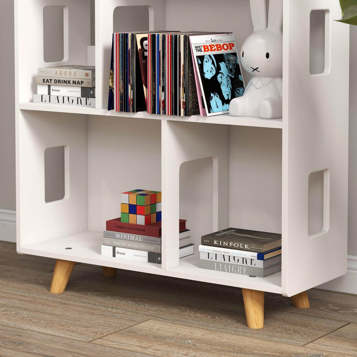 White house-shaped toy storage shelf with 6 cubbies and colorful book spines