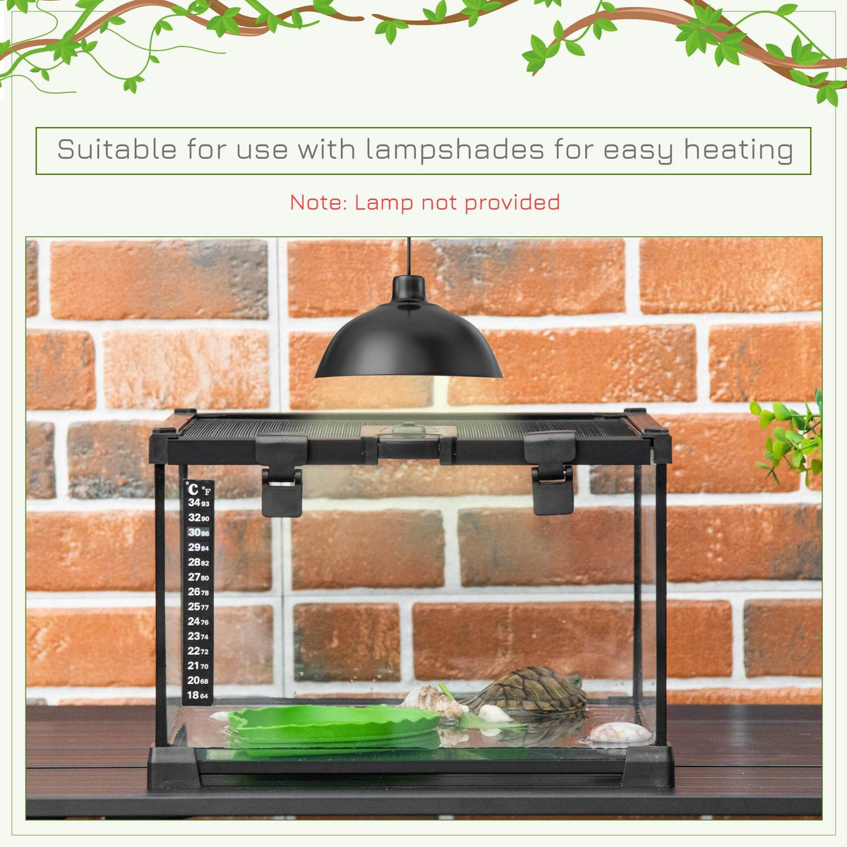 Black reptile terrarium on base with heating lamp above and thermometer scale at left
